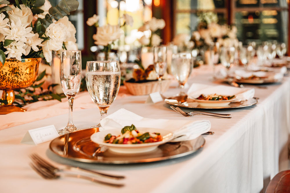 Elegant table setting showcasing gourmet wedding menu dishes.