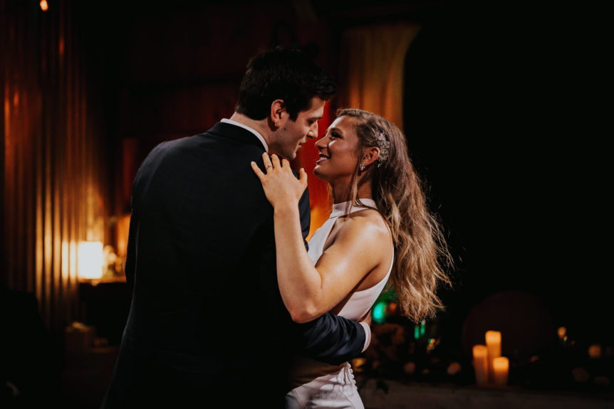 Bride and Groom in a Romantic Dance Embrace with an Adoring Gaze at Wedding Reception
