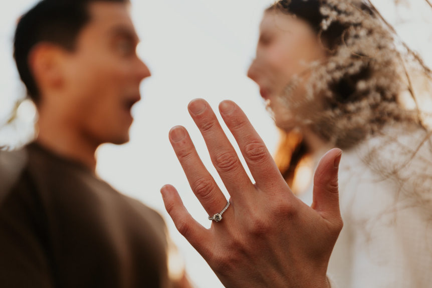 Happy Newly Engaged Couple Showing Engagement Ring