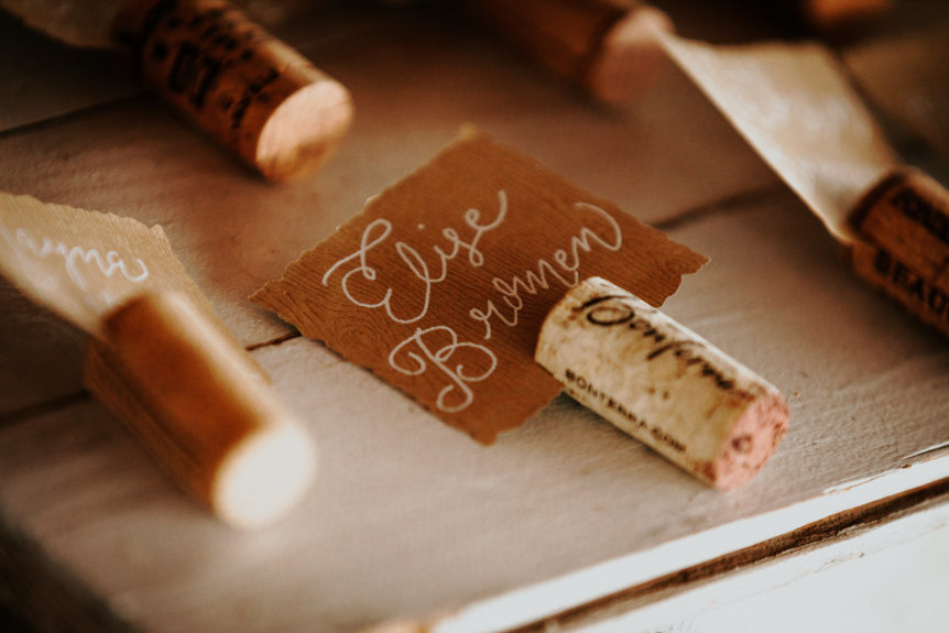 Wine cork used as a place card holder with attached name tag for wedding seating