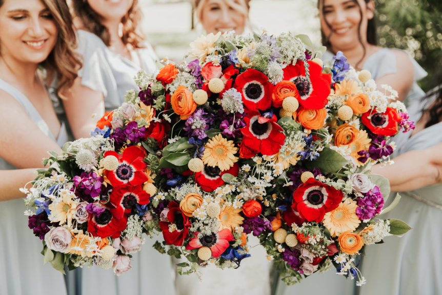 Bride and Bridesmaids with Colorful Bouquets Showcasing Top Flowers for Wedding Season