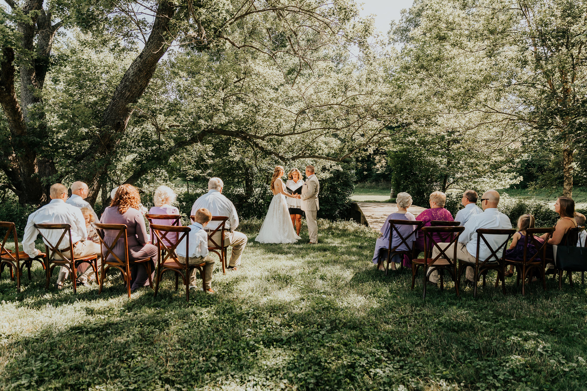 Bridal Couple Exchanging Vows at a Brunch Wedding Garden Ceremony