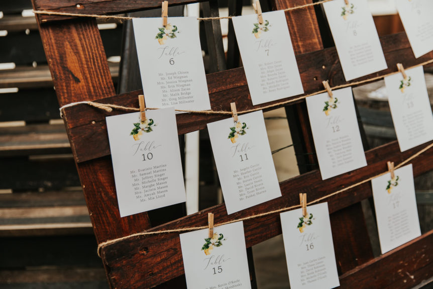 Elegant wedding reception table seating chart with neatly arranged place cards.