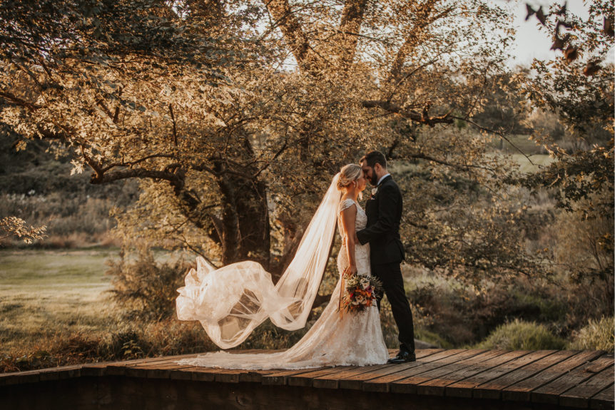 Bridal Couple on Wooden Bridge with Flowing Veil at Zion Springs