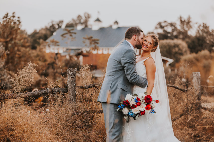 Newlyweds embrace - rustic barn wedding