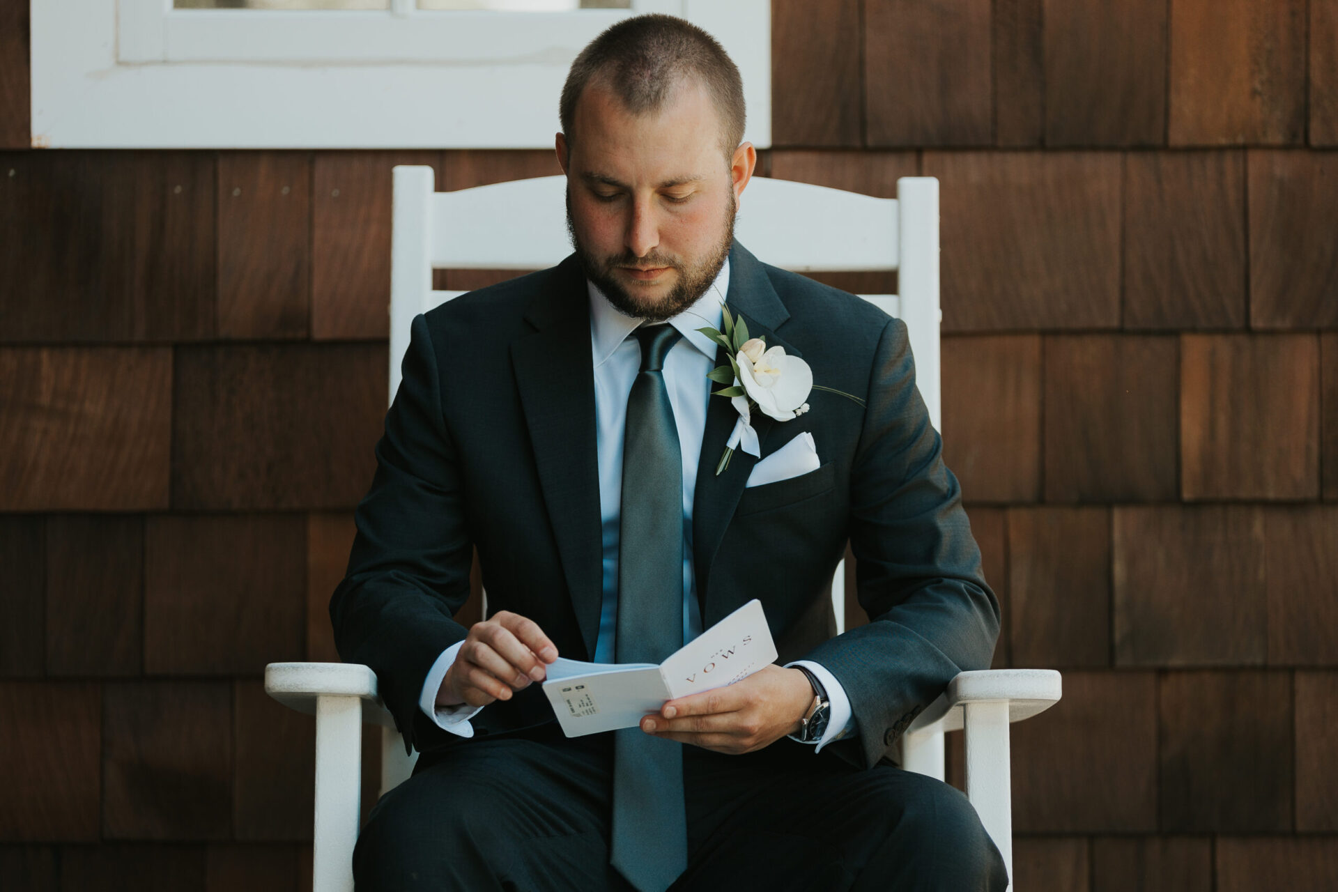 Zion Springs groom reviewing wedding vows, rustic barn