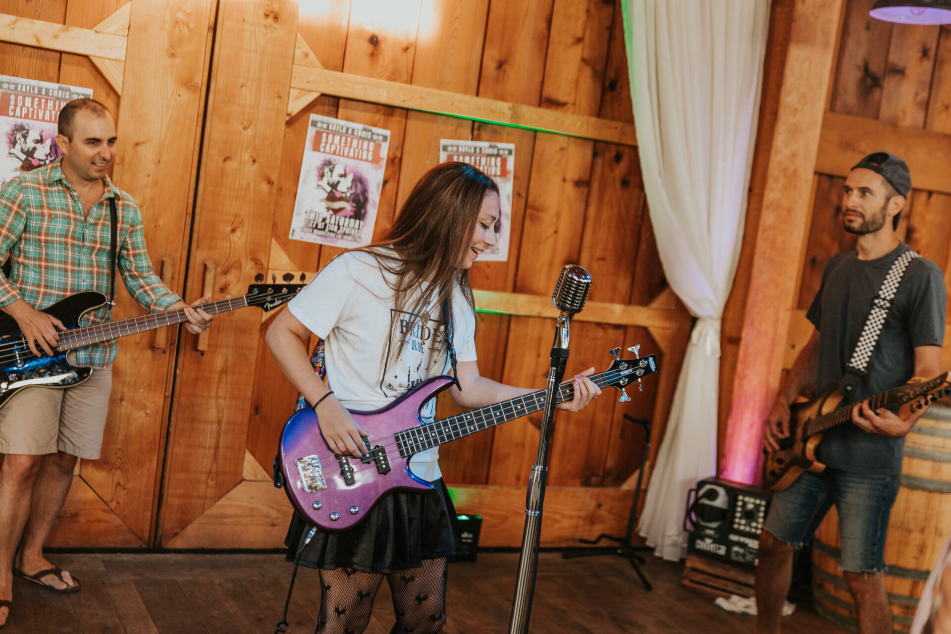 Kayla and Christopher playing electric guitar in Zion Springs barn