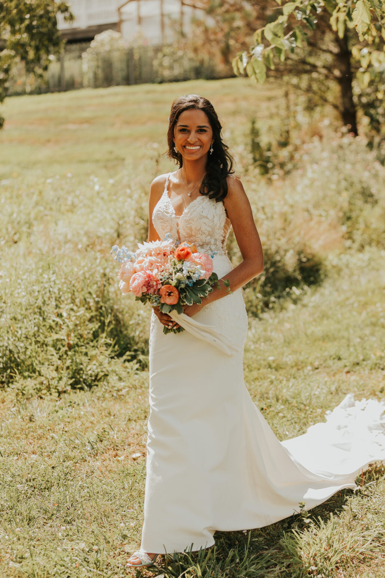 zion springs bride walking in field with bouquet