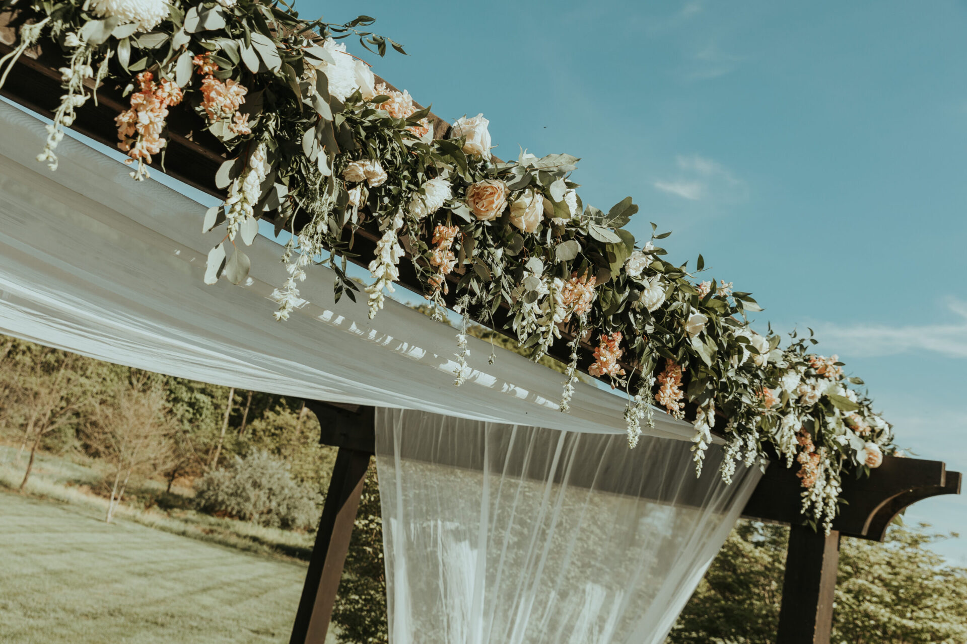 beautiful flowers on pergola for Zion Springs wedding