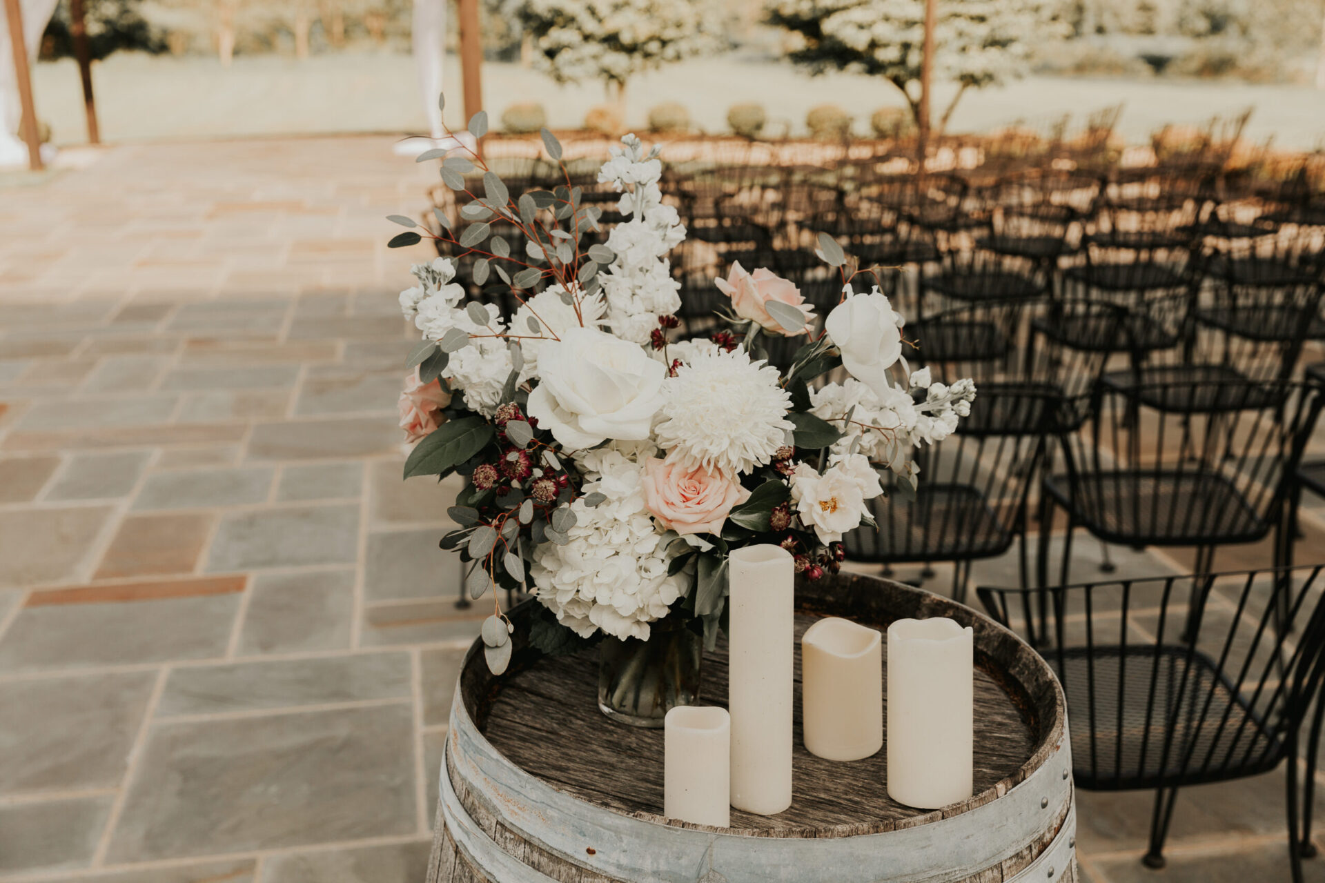 Zion Springs led candles and flower arrangement on rustic barrell with wedding seating