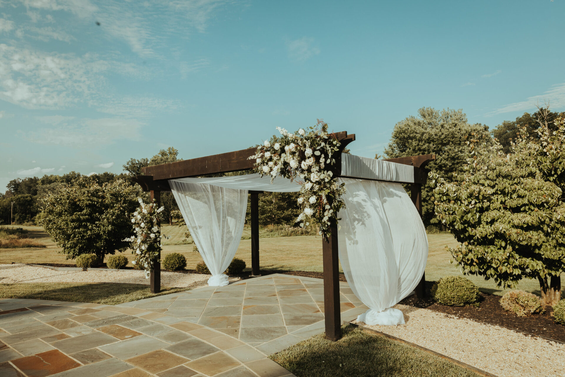 Zion Springs wedding pergola with flowers and soft fabric gently blowing in the breeze