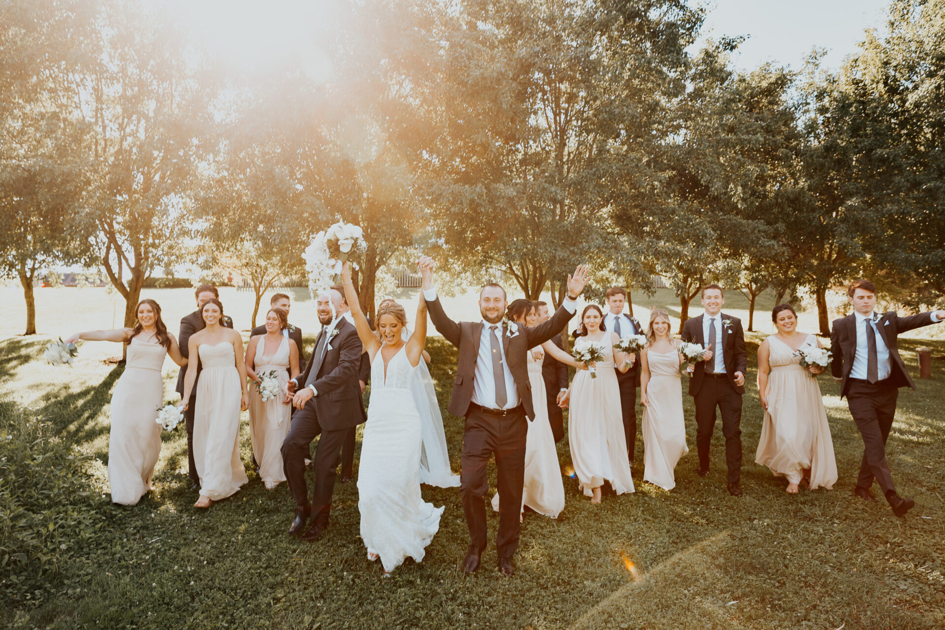 Zion Springs bride and groom celebrating with wedding party on estate lawn