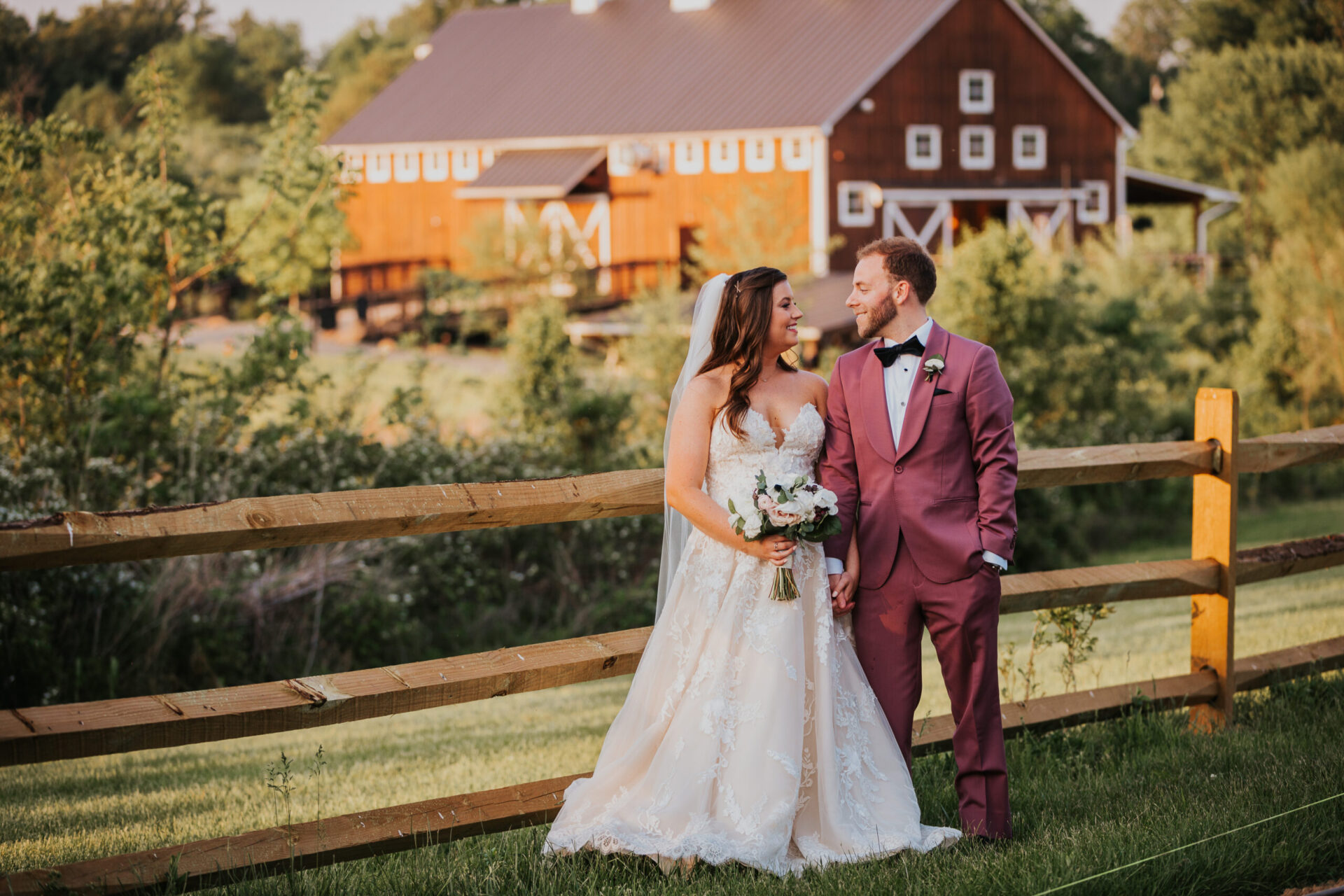 Zion Springs bride and groom wooden fence rustic barn