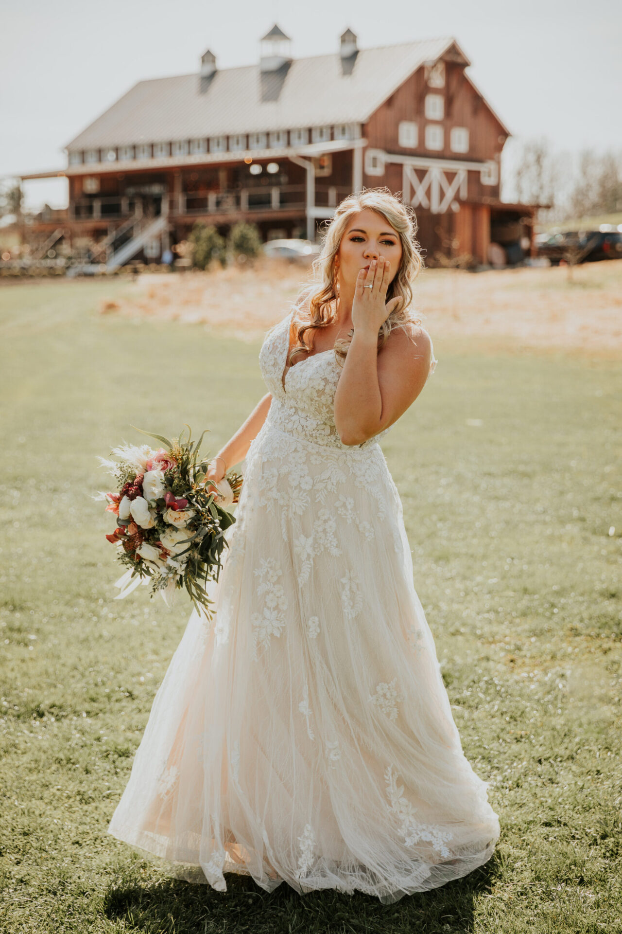 Zion Springs bride on lawn in front of rustic barn