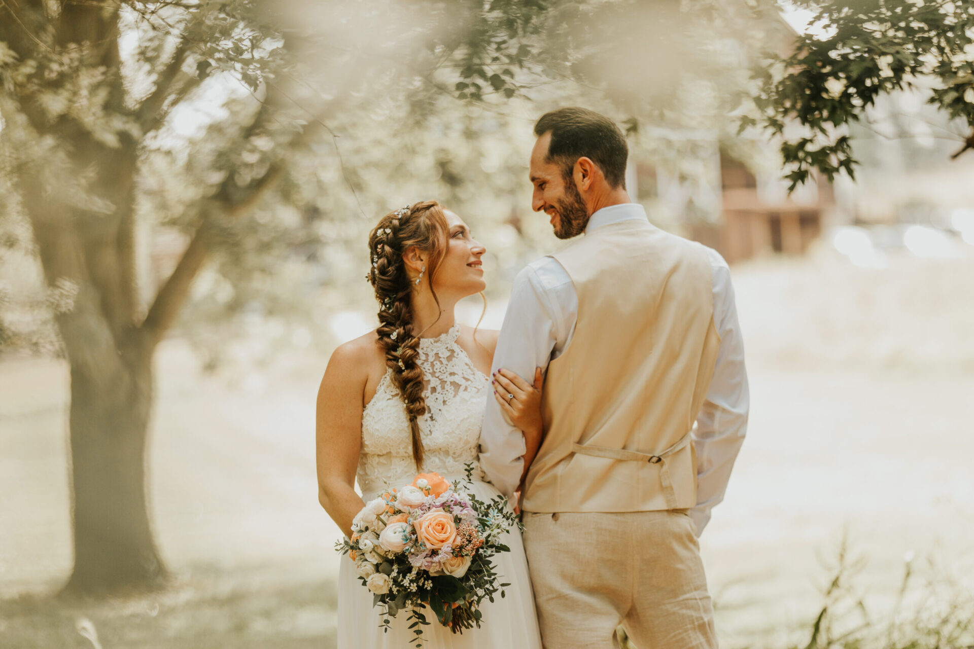 Wedding couple standing under walnut tree at Zion Springs