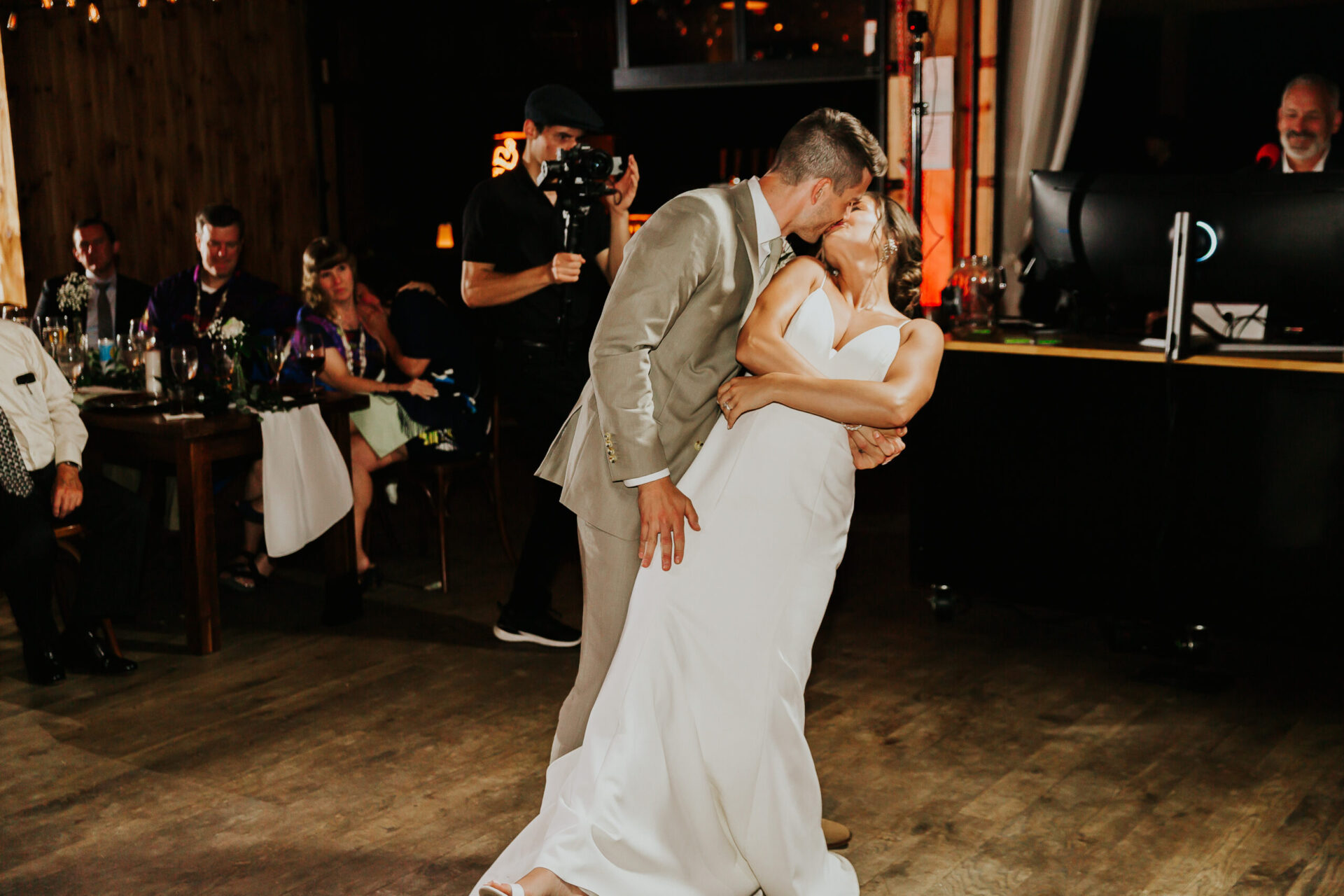 bride and groom dance in rustic barn