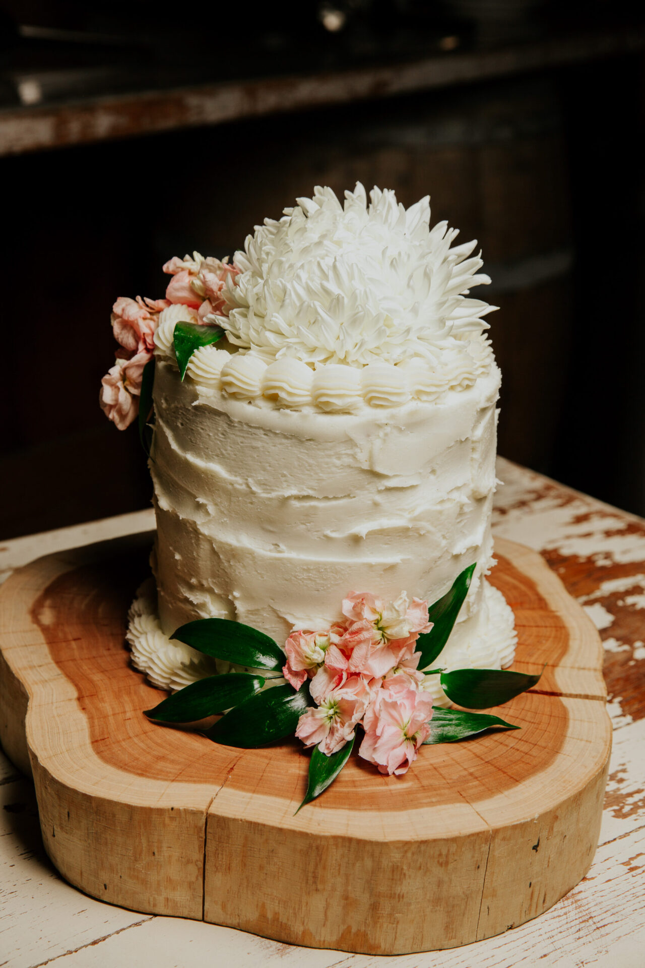wedding cake on wood platter