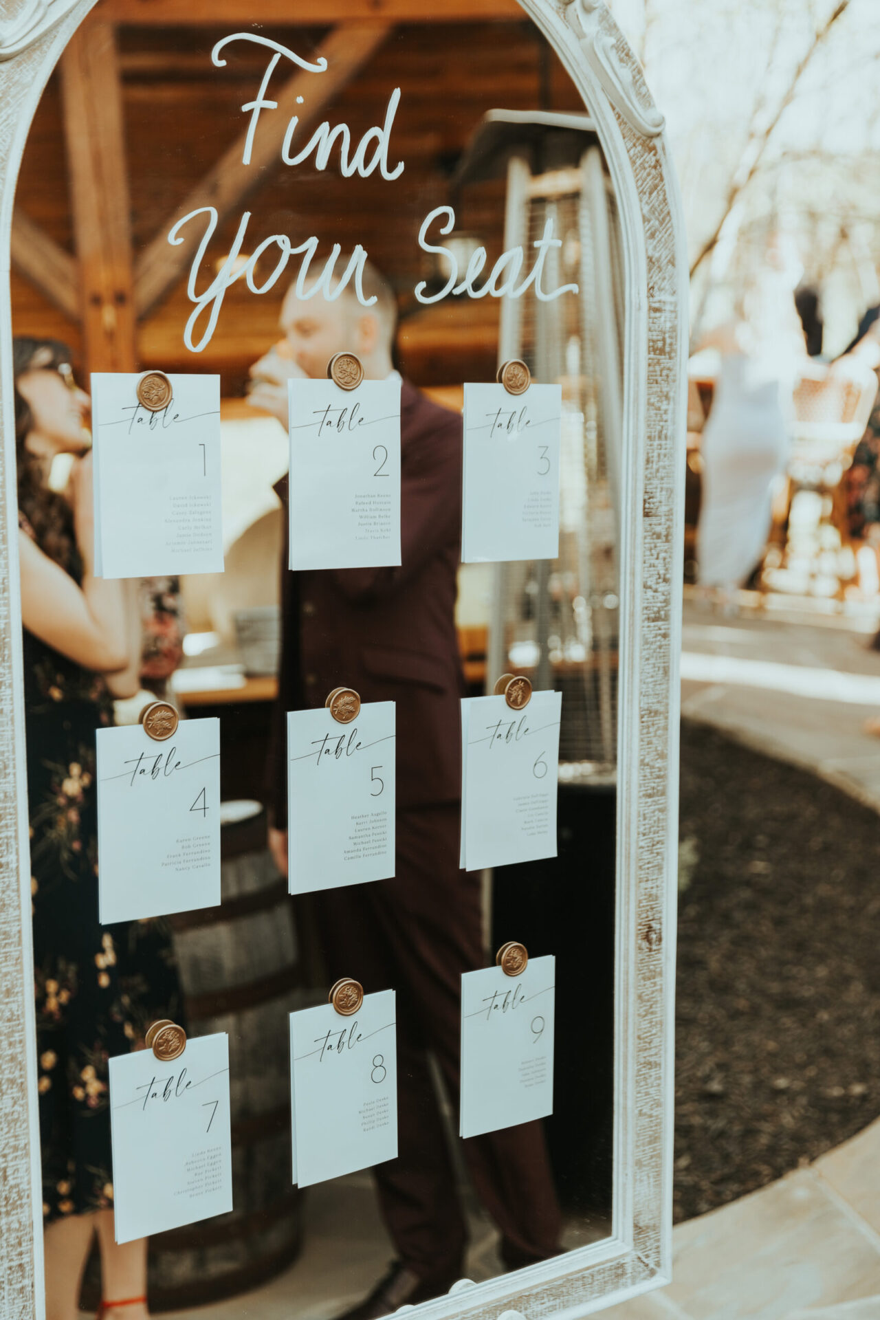 seat chart on mirror for wedding reception
