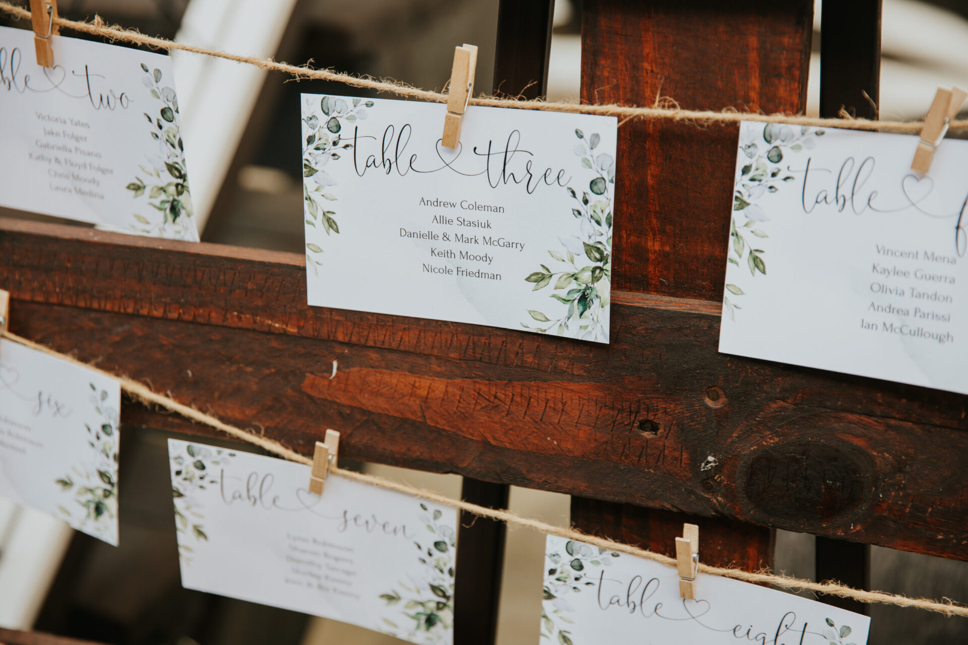 seating chart at Zion Springs for wedding reception, cards pegged onto string with wood frame