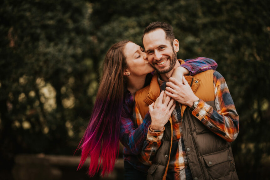 engaged couple kissing under trees at Morven Park