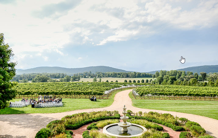 Elegant outdoor wedding ceremony setup at Keswick Vineyards with panoramic views of Virginia's landscape.