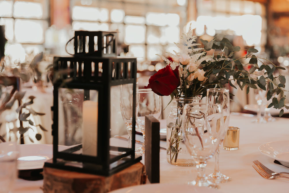 Elegant wedding table decor with flowers and lanterns at Zion Springs barn venue.