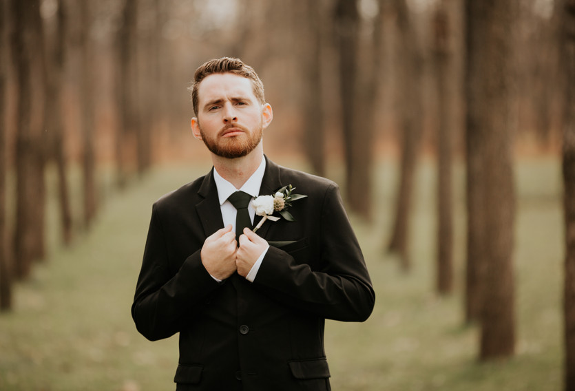 groom standing in Zion Spring walnut grove