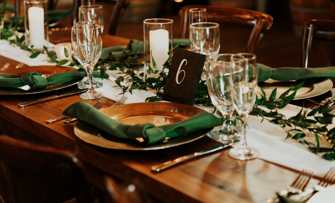 green napkin with dinner setting and glasses