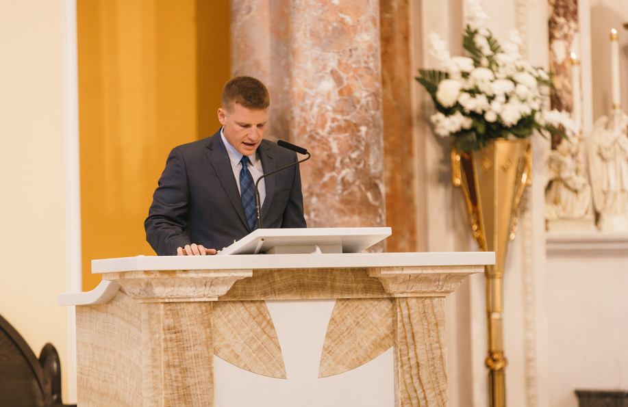 man reading scripture during wedding ceremony