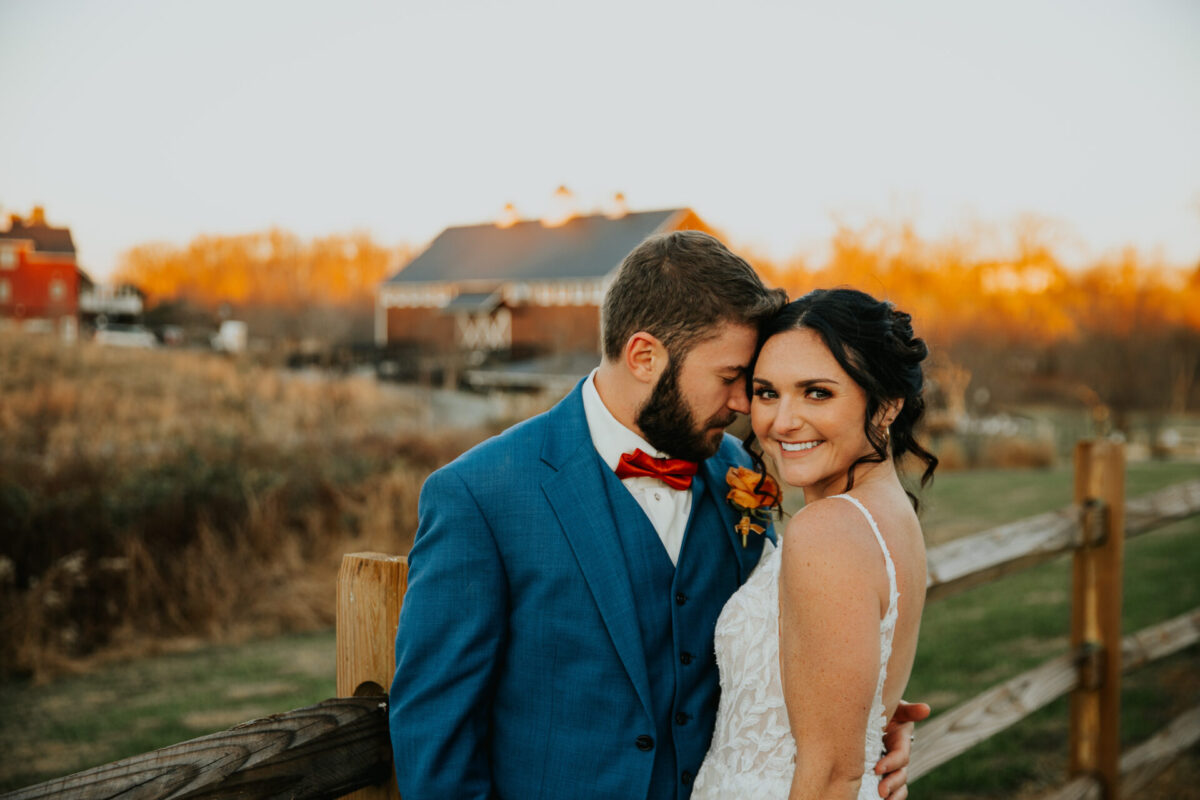 bride, groom, rustic barn, wood fence