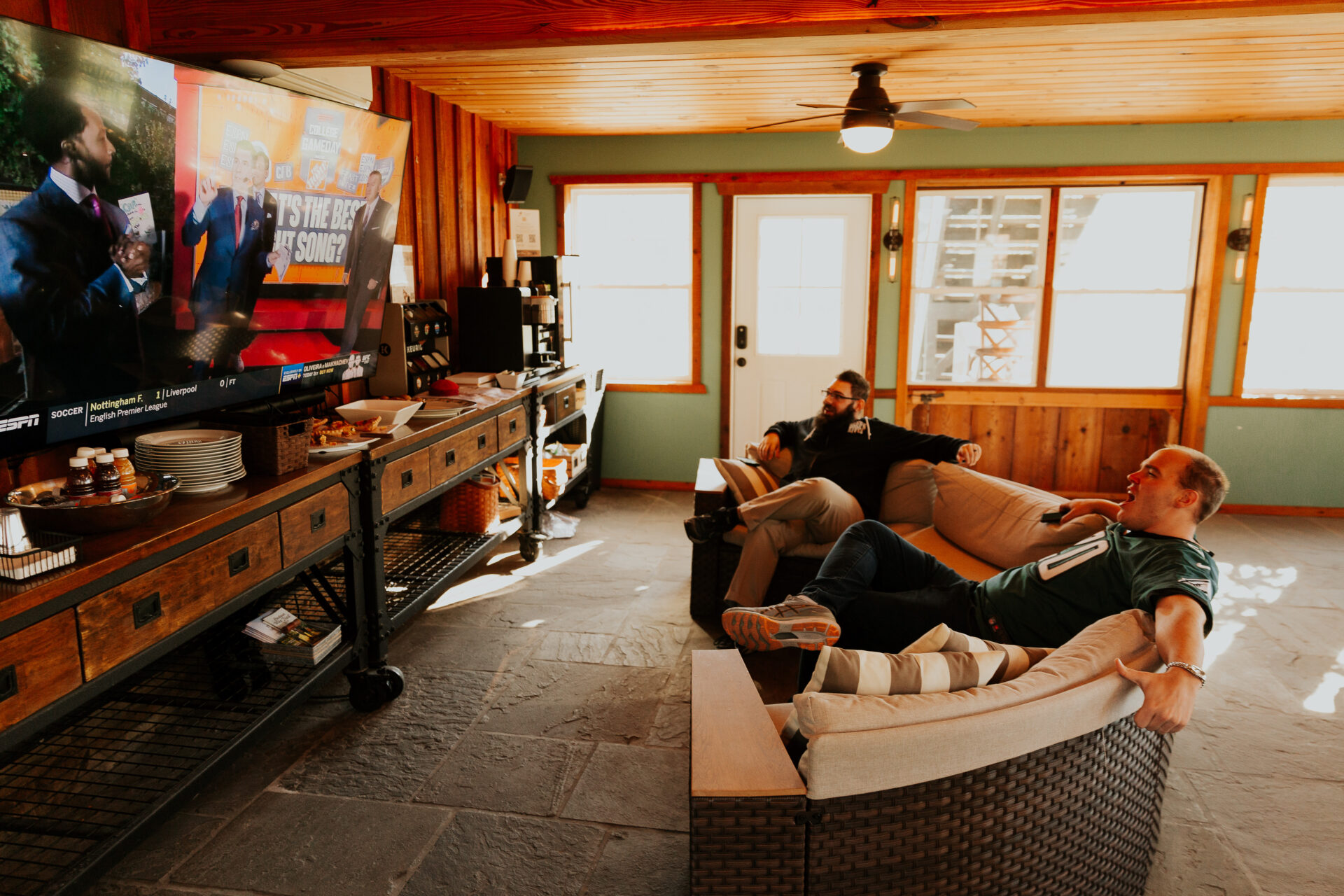 men relaxing in front of tv in Zion Springs Green room