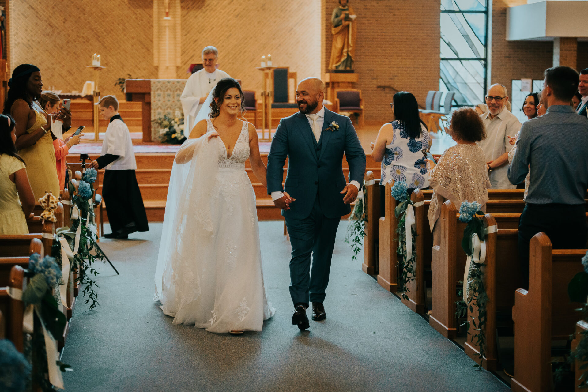 bride and groom walking down church aisle