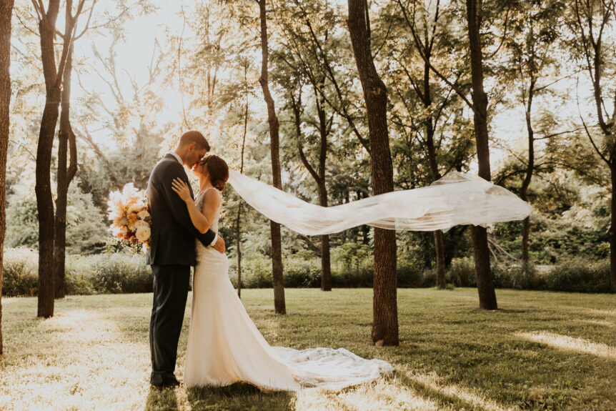 Newlyweds sharing a romantic moment in the Walnut Grove at Zion Springs, a scenic barn wedding venue in Northern Virginia.