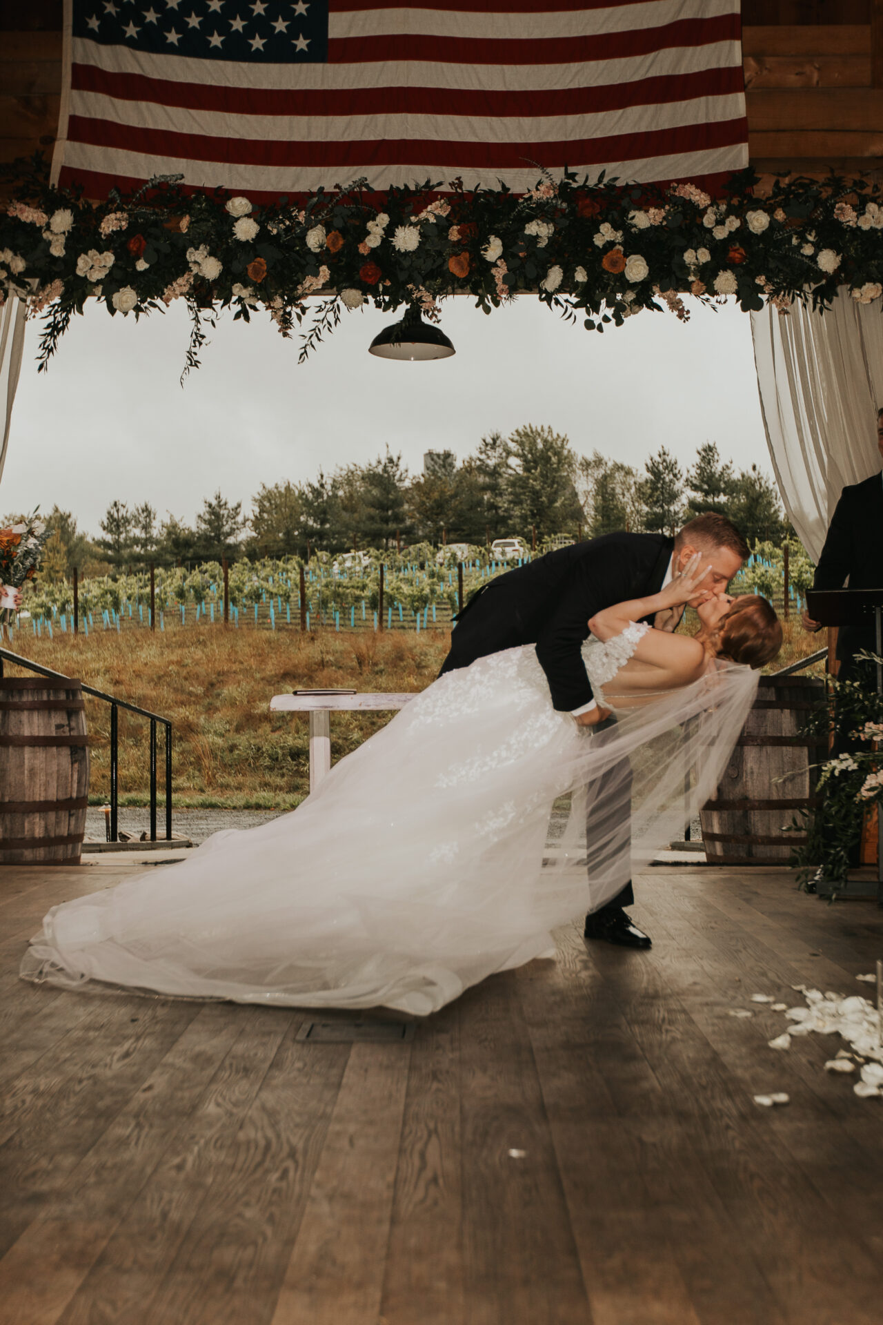 bride, groom, first kiss, rustic barn, vineyard