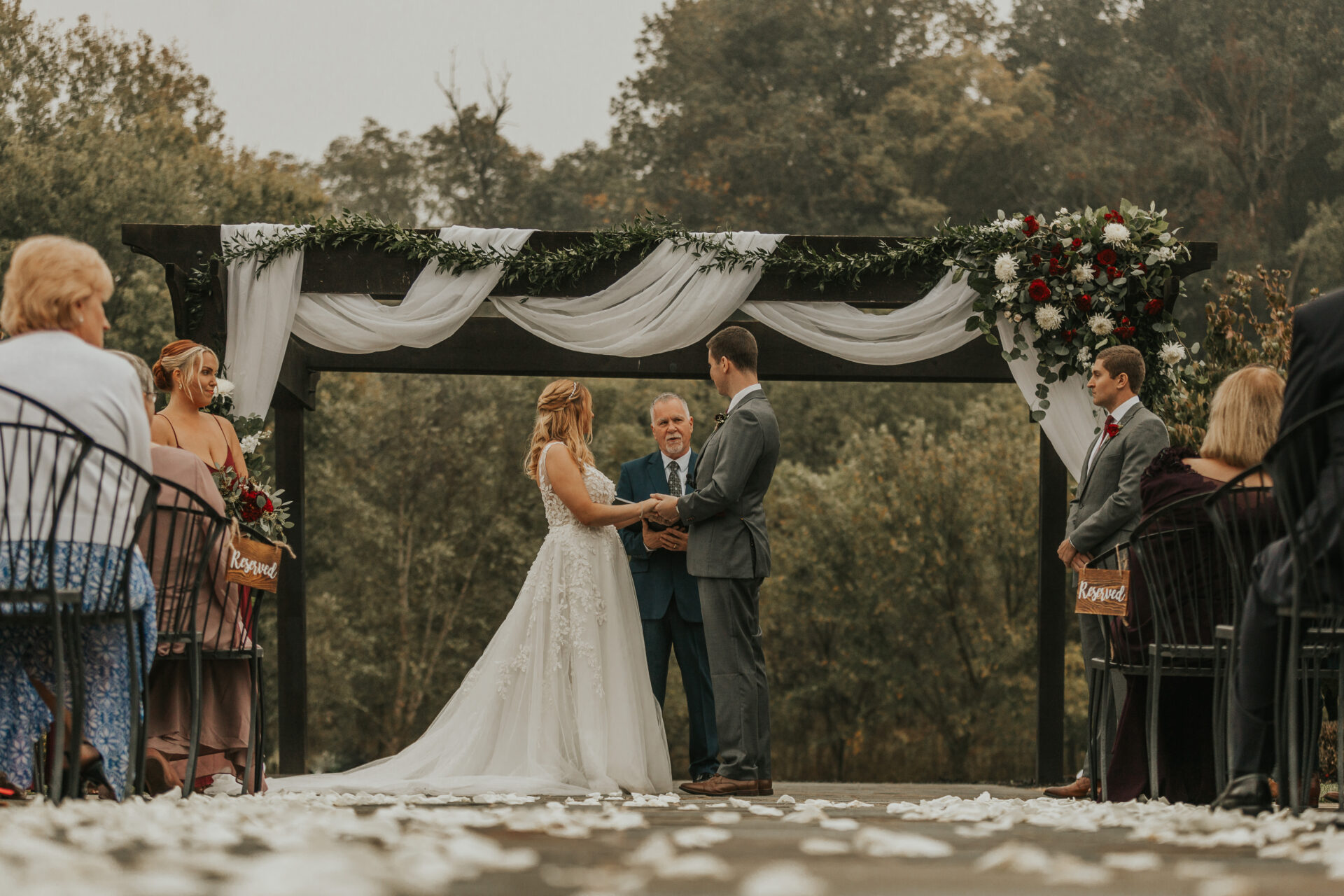 wedding ceremony, pergola, officiant, bride, groom, bridal party, wedding florals, rustic barn, outside wedding