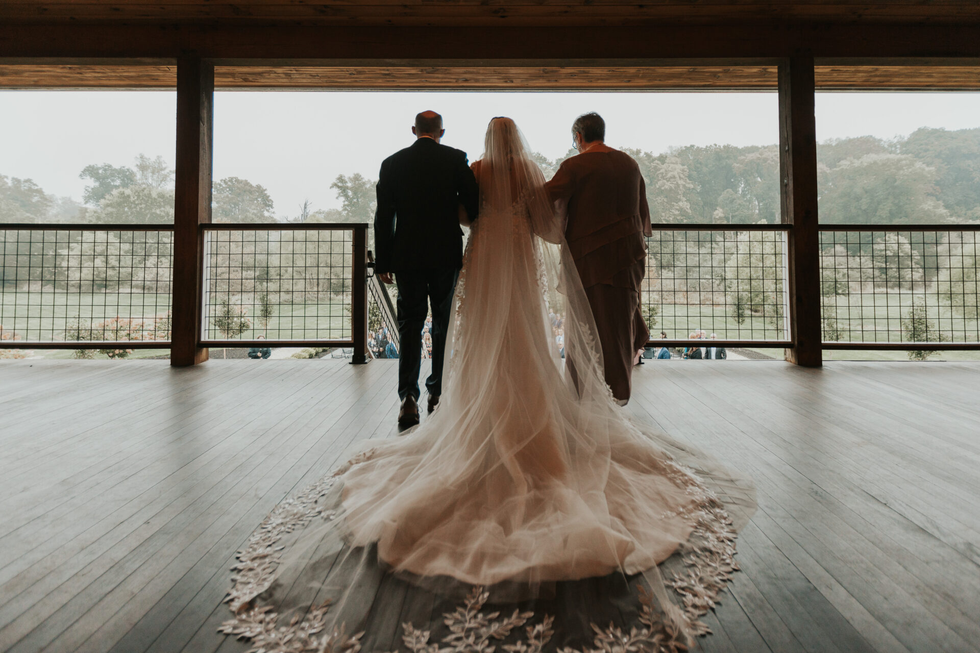 bride, father of the bride, mother of the bride, rustic barn, walking down the aisle