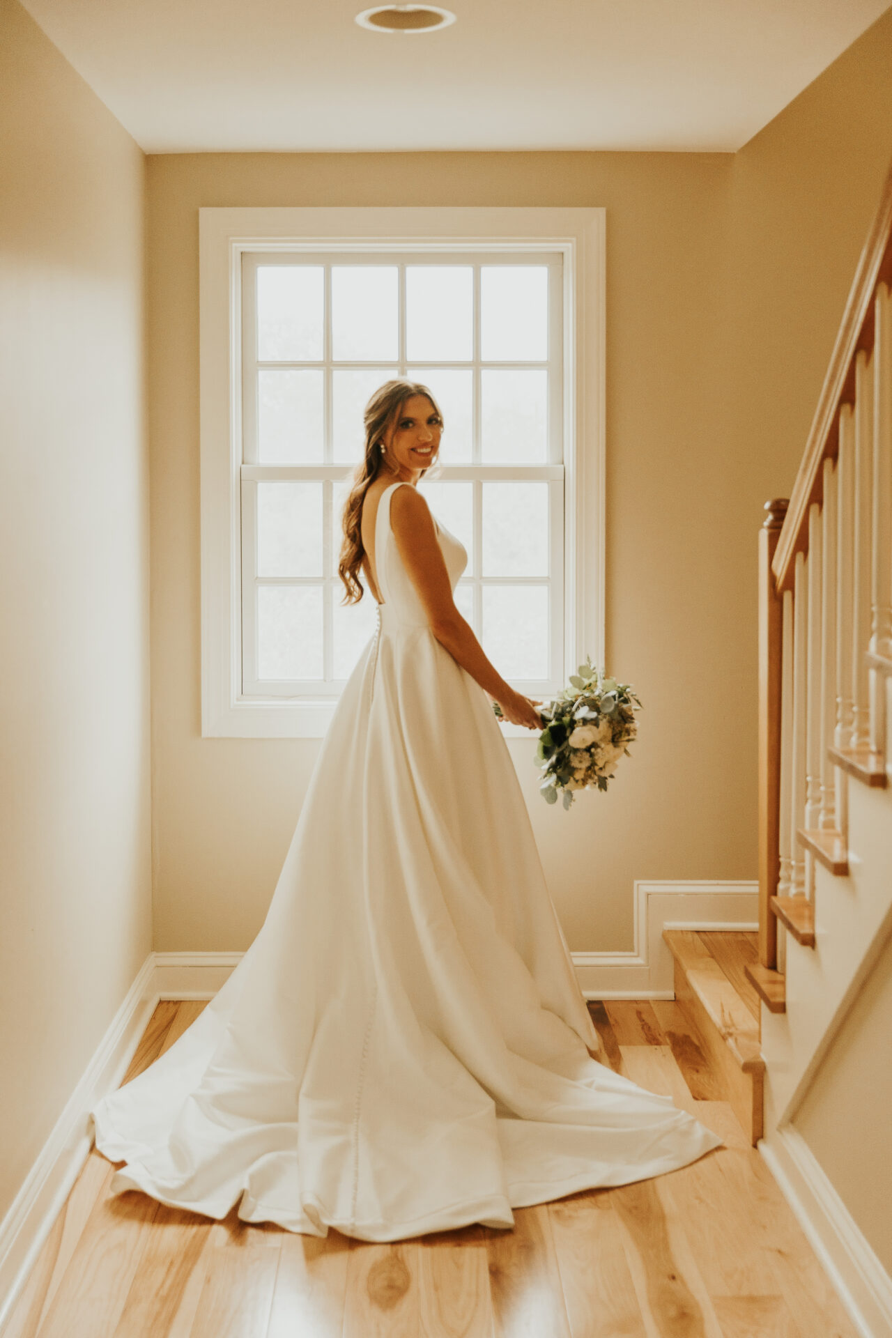 bride, silhoette, cream hallway, wedding dress, bouquet