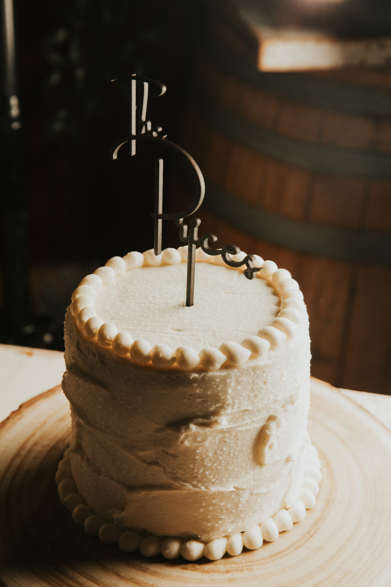 white wedding cake, rustic barrel