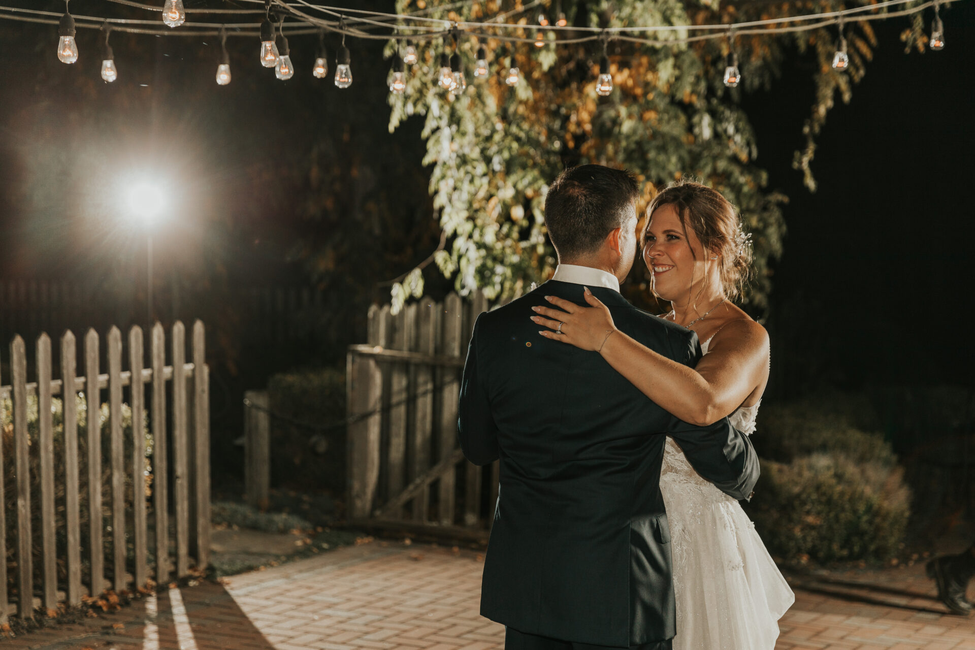 bride, groom, dancing, night lights, rustic barn