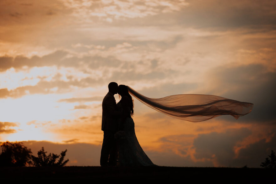 Newlyweds sharing a romantic moment at Zion Springs, an all-inclusive barn wedding venue in Loudoun County.