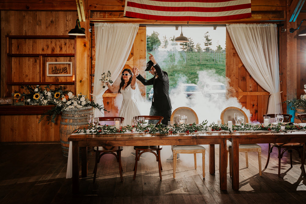 Bridal couple making an entrance at Zion Springs barn, ideal for rustic, elegant wedding receptions in Loudoun County.